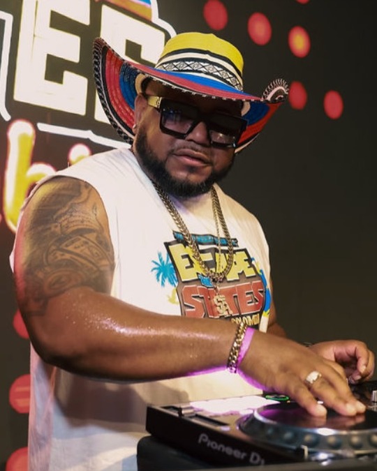 DJ Tight in his signature Colombian hat performing behind the Pioneer decks at Escape The States